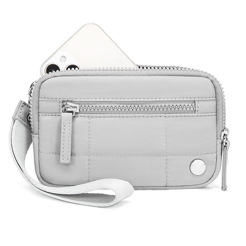 Gray waterproof quilted handbag with wrist strap and front zipper, made of nylon for tech gadgets and daily essentials.