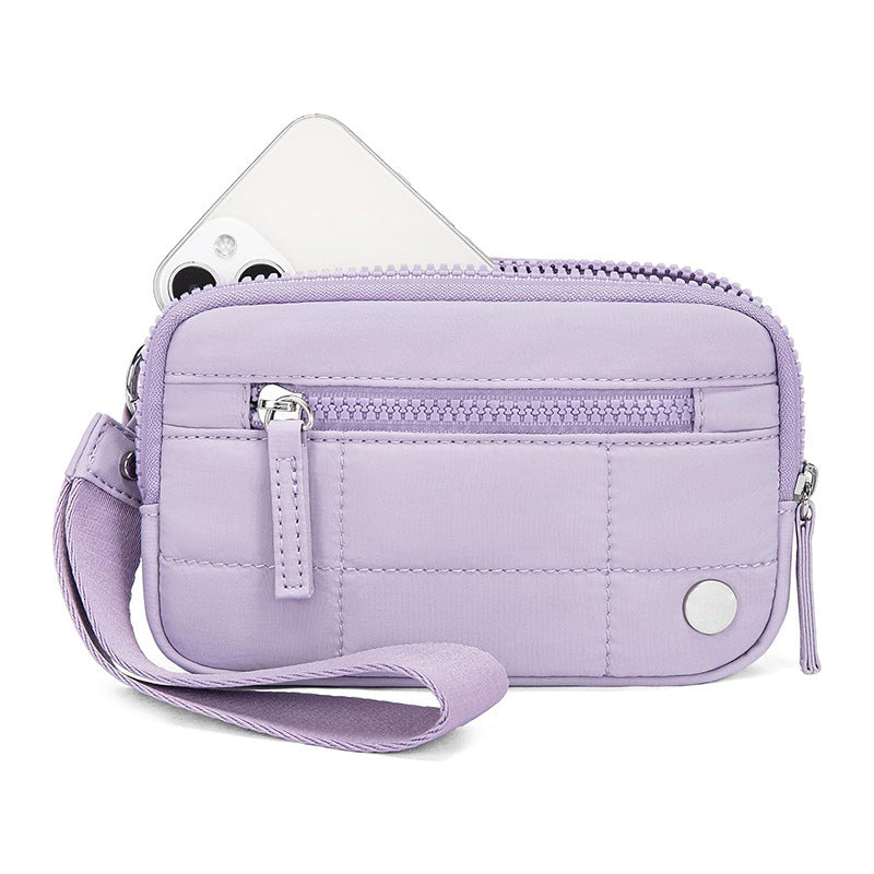 Light purple waterproof quilted handbag with wrist strap and front zipper, made of nylon for tech gadget storage and daily use.