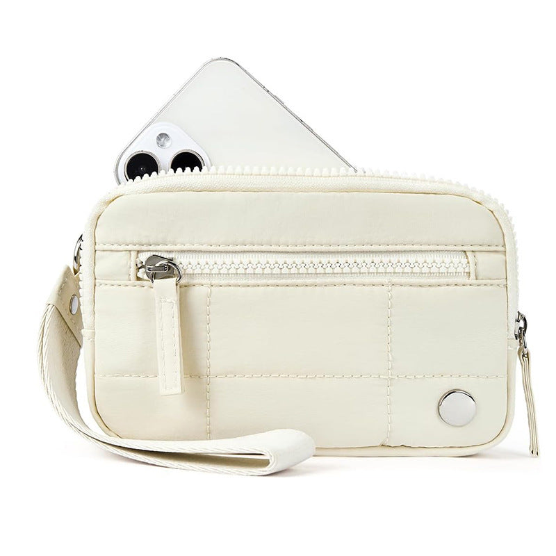 White waterproof quilted handbag for women with front zipper pocket and wrist strap, made from nylon for daily tech gadget use.